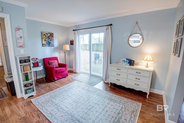 sitting room with crown molding and hardwood / wood-style floors