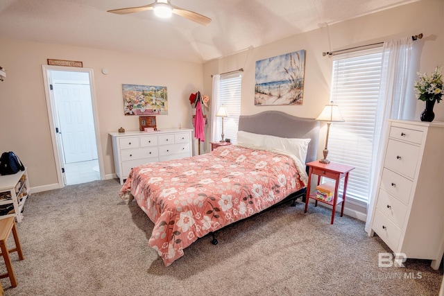 carpeted bedroom with multiple windows, vaulted ceiling, and ceiling fan