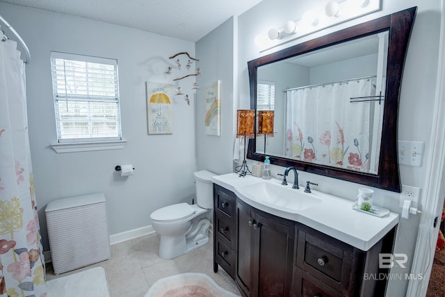 bathroom with vanity, toilet, and a textured ceiling