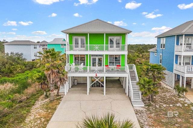 rear view of house with a carport and a balcony