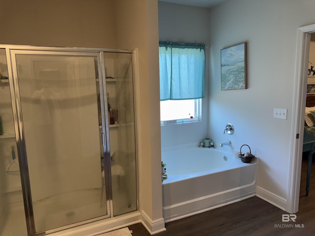 bathroom featuring hardwood / wood-style flooring and plus walk in shower