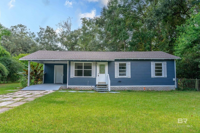 single story home featuring a front lawn and a carport