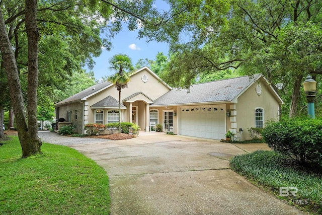 11346 County Road 99, Lillian, AL 36549 - view of front of home featuring concrete driveway, an attached garage, and stucco siding