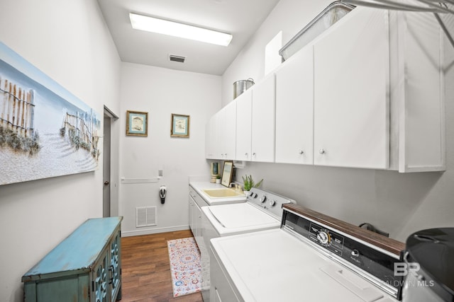 11346 County Road 99, Lillian, AL 36549 - laundry area with cabinet space, separate washer and dryer, dark wood-style flooring, and baseboards