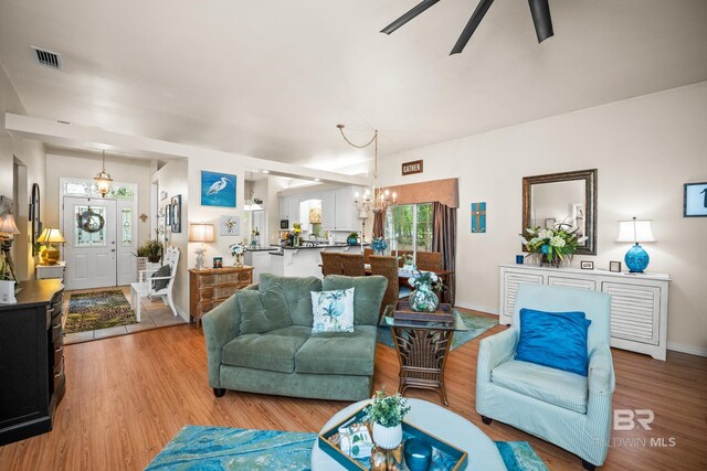 11346 County Road 99, Lillian, AL 36549 - living room featuring a chandelier, a ceiling fan, and light wood-style floors
