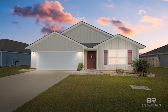 view of front of home featuring a lawn and a garage