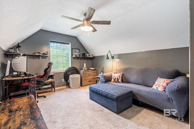 interior space featuring a textured ceiling, vaulted ceiling, carpet floors, and ceiling fan