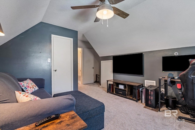 living room with a textured ceiling, vaulted ceiling, light colored carpet, and ceiling fan