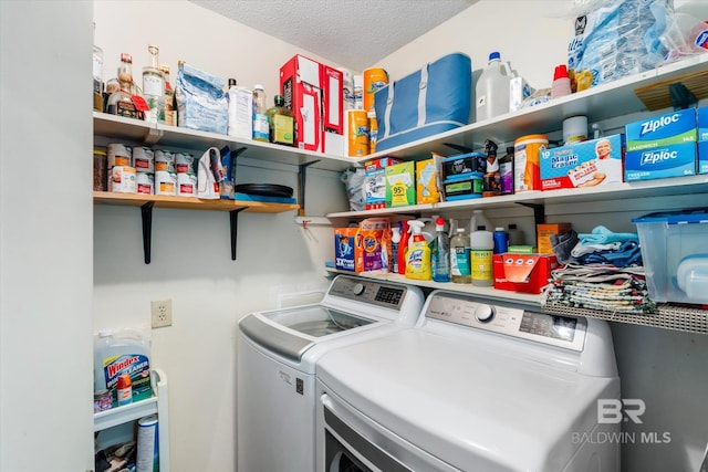 laundry area featuring washer and dryer and a textured ceiling