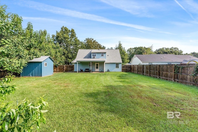 rear view of house featuring a storage unit and a lawn