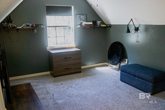 living area featuring lofted ceiling and carpet