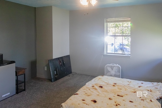 carpeted bedroom with refrigerator and ceiling fan