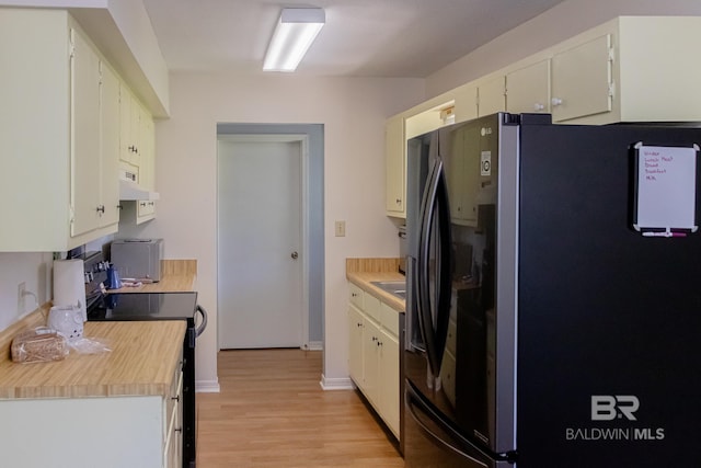 kitchen featuring light hardwood / wood-style flooring, stainless steel refrigerator with ice dispenser, ventilation hood, stove, and white cabinets