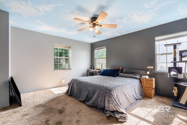 carpeted bedroom featuring ceiling fan