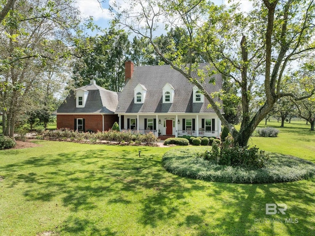 cape cod-style house with a front yard and covered porch