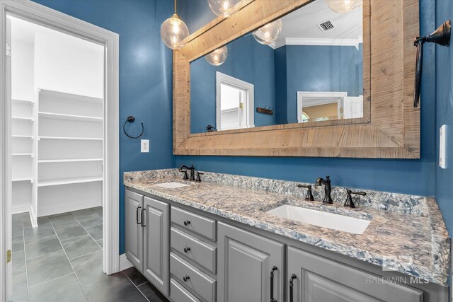 bathroom featuring ornamental molding, tile patterned flooring, and vanity