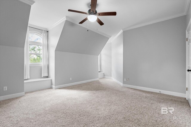 additional living space featuring ceiling fan, lofted ceiling, and light carpet