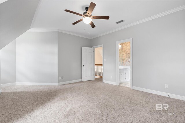 unfurnished bedroom featuring connected bathroom, ornamental molding, ceiling fan, and light colored carpet