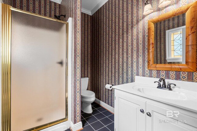 bathroom featuring vanity, crown molding, a shower with door, toilet, and tile patterned floors