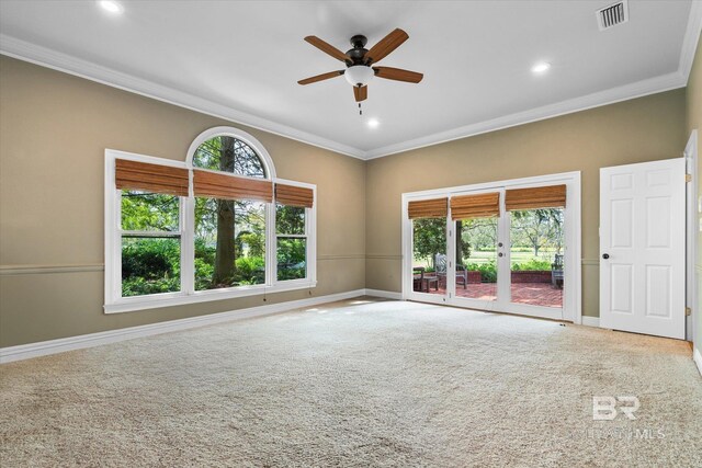 empty room featuring crown molding, carpet flooring, and ceiling fan