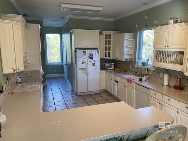 kitchen featuring white appliances, tasteful backsplash, sink, and white cabinetry