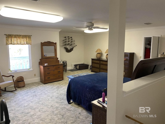 bedroom with ceiling fan, carpet, and crown molding