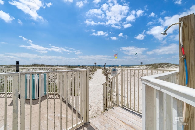 surrounding community with a beach view and a water view