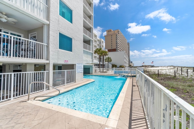 pool with fence and a patio area