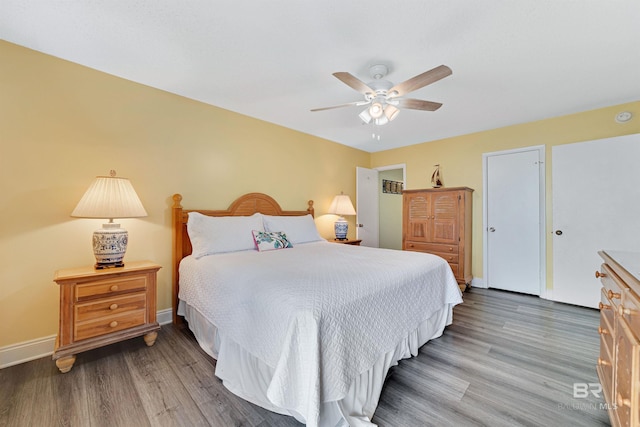 bedroom with baseboards, ceiling fan, and wood finished floors