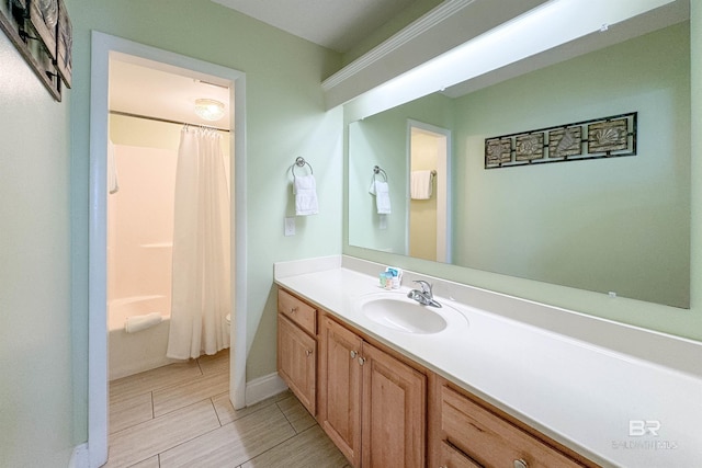 bathroom featuring shower / bath combo with shower curtain, toilet, baseboards, and vanity