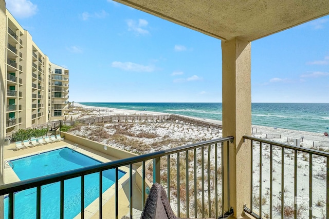 balcony featuring a water view and a view of the beach
