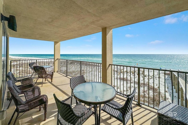 balcony featuring a water view and a view of the beach