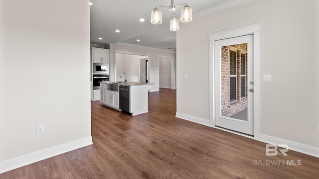 10253 Secretariat Blvd, Daphne, AL 36526 - kitchen featuring ornamental molding, oven, a kitchen island with sink, white cabinetry, and baseboards
