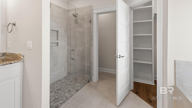 10253 Secretariat Blvd, Daphne, AL 36526 - full bathroom featuring a stall shower, vanity, tile patterned flooring, and baseboards