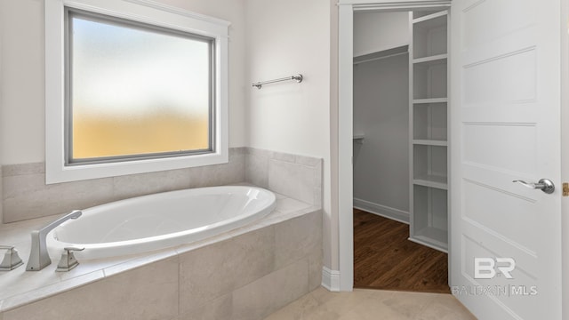 10253 Secretariat Blvd, Daphne, AL 36526 - full bathroom with plenty of natural light, a garden tub, a spacious closet, and tile patterned flooring