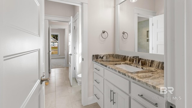 10253 Secretariat Blvd, Daphne, AL 36526 - bathroom with toilet, vanity, tile patterned flooring, and baseboards