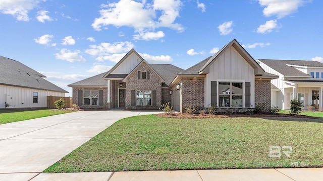 10253 Secretariat Blvd, Daphne, AL 36526 - view of front facade with board and batten siding, brick siding, and concrete driveway