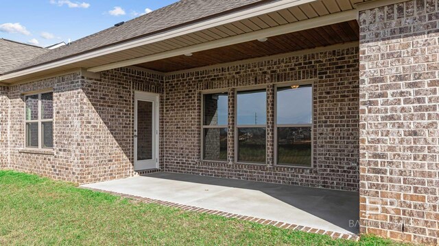 10253 Secretariat Blvd, Daphne, AL 36526 - property entrance featuring brick siding, a patio area, and roof with shingles