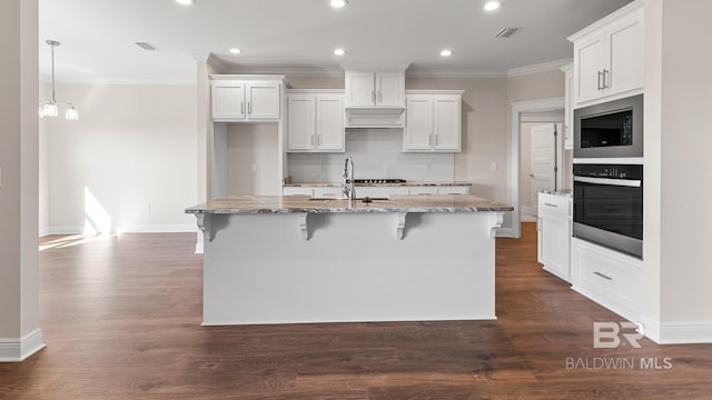 10253 Secretariat Blvd, Daphne, AL 36526 - kitchen with stainless steel appliances, a sink, ornamental molding, decorative backsplash, and a center island with sink