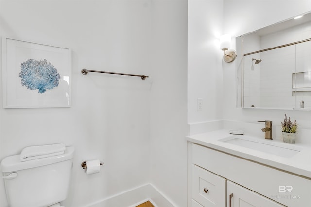 bathroom with vanity, toilet, and walk in shower