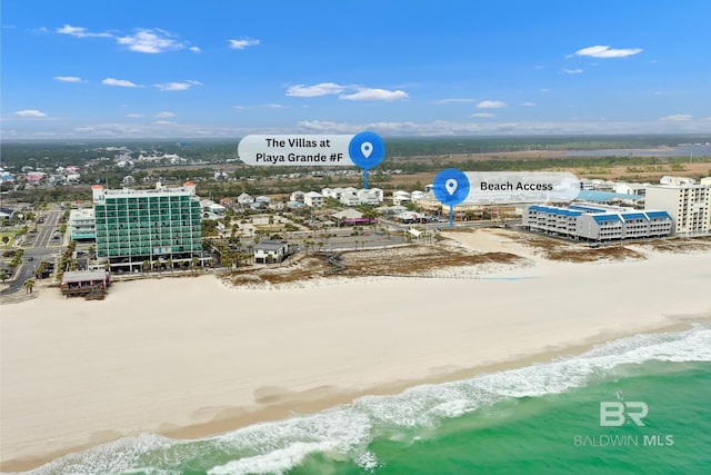 birds eye view of property with a view of the beach and a water view