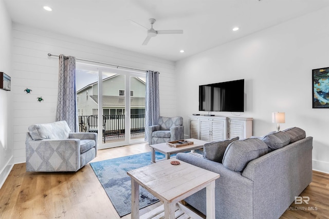 living room featuring hardwood / wood-style flooring and ceiling fan