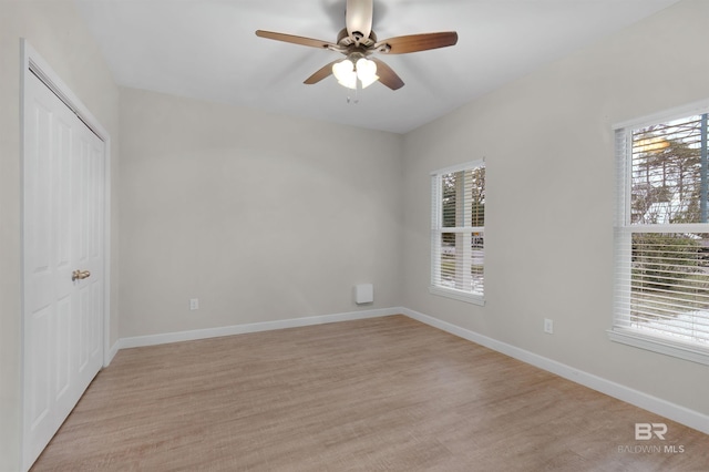 spare room with light hardwood / wood-style floors and ceiling fan