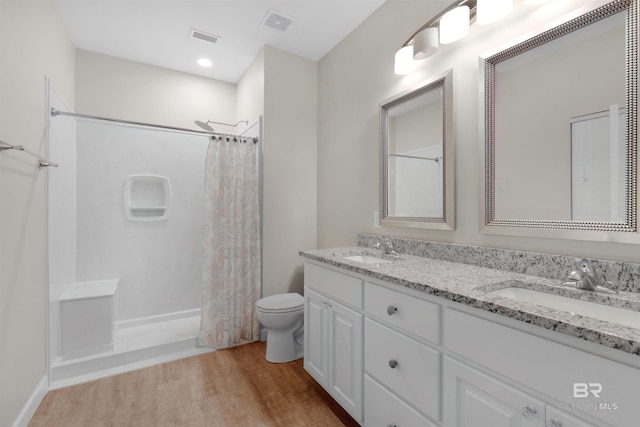 full bathroom with toilet, shower / bath combination with curtain, wood-type flooring, and vanity