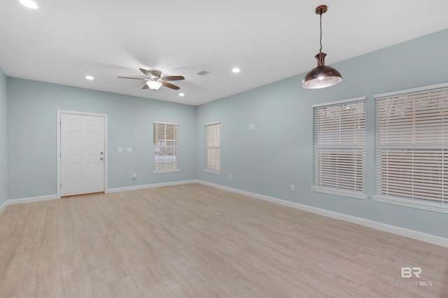 spare room with ceiling fan and light hardwood / wood-style flooring