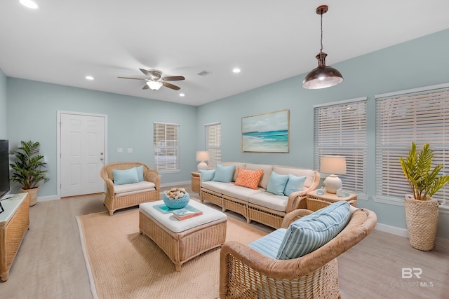 living room featuring ceiling fan and light hardwood / wood-style flooring