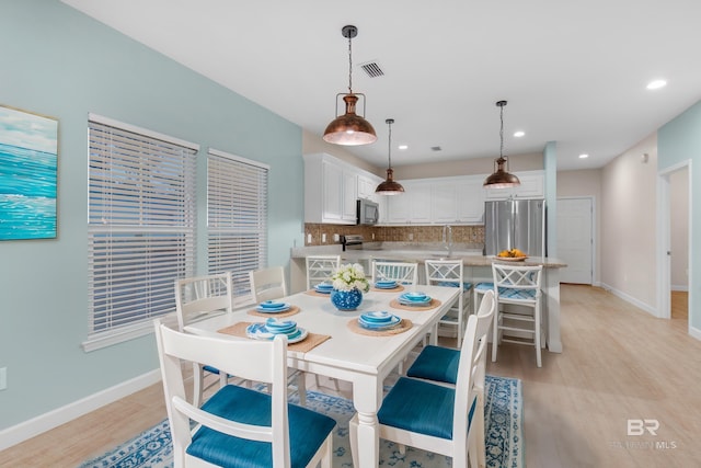 dining area featuring light wood-type flooring