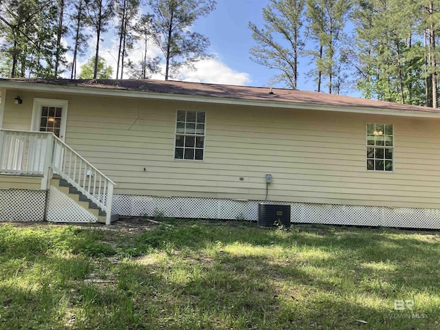 back of property with a lawn