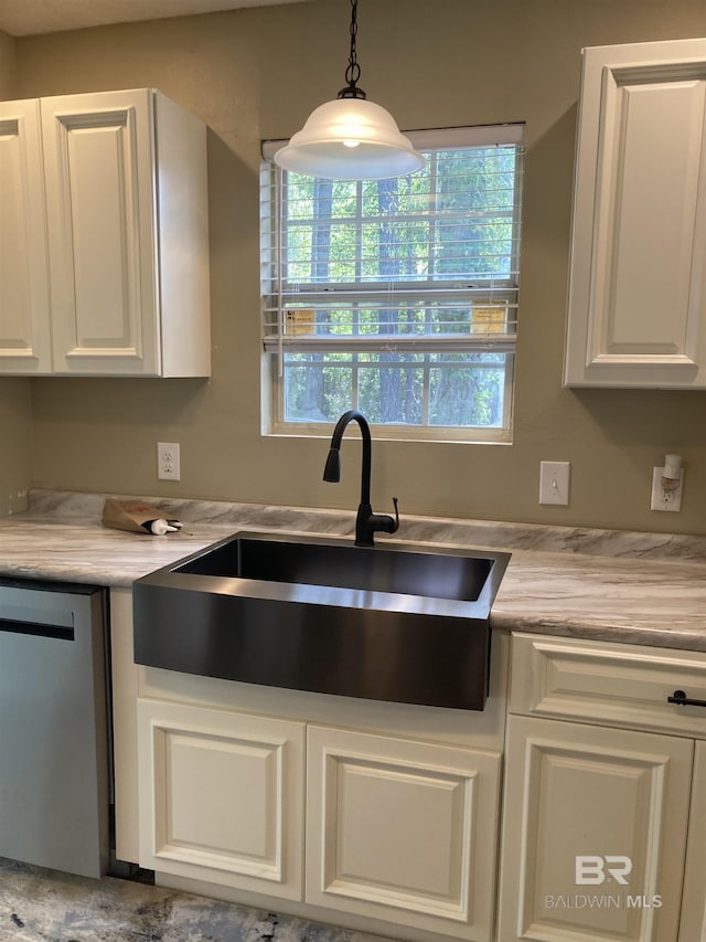 kitchen featuring light countertops, a sink, white cabinetry, dishwasher, and decorative light fixtures