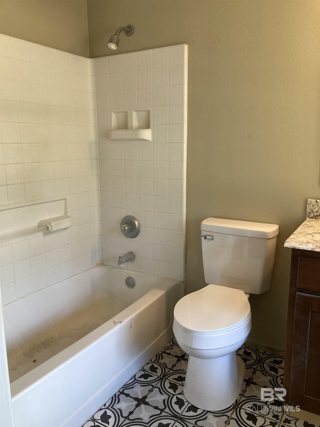 bathroom featuring tile patterned floors, shower / bathtub combination, vanity, and toilet
